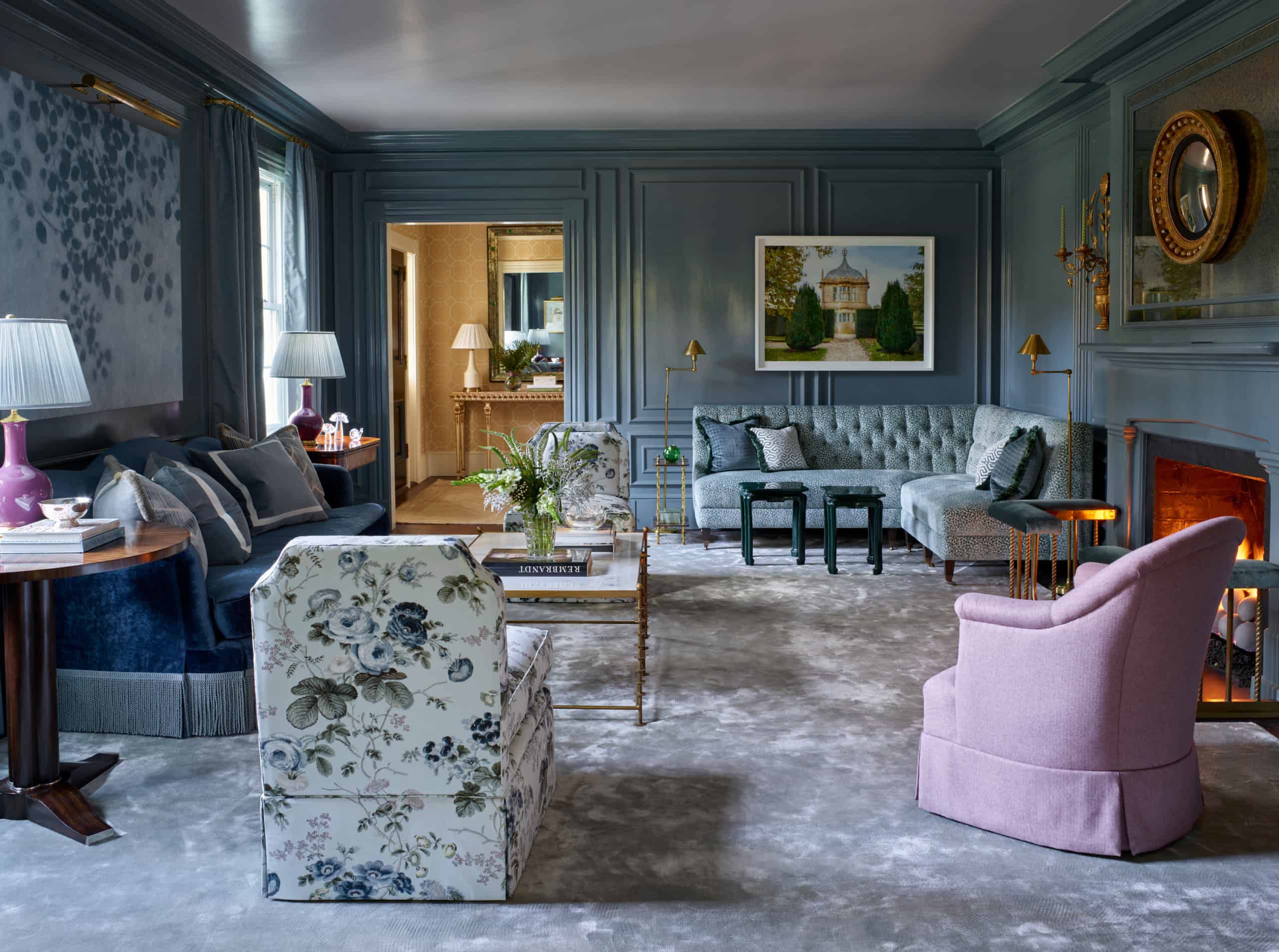Elegant living room with classic decor and plush furniture in blue and pink tones.