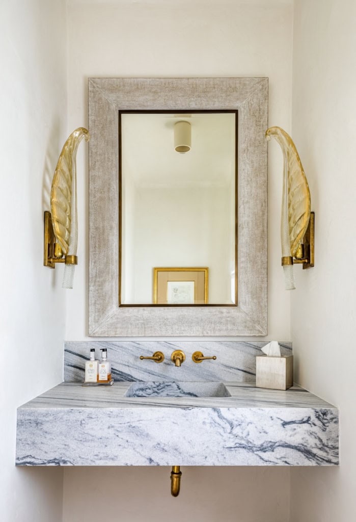 Elegant bathroom vanity with marble countertop and gold fixtures by Helen Hanavich.